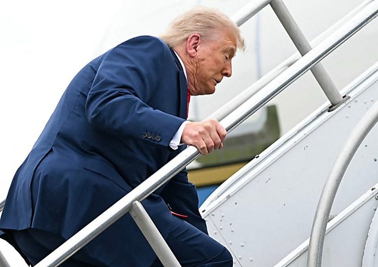 Трамп ледь не впав, піднімаючись трапом літака (відео)